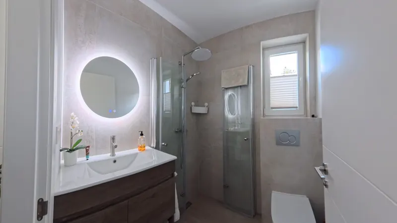 Ground Floor Bathroom: Round LED Mirror & Walk-in Shower