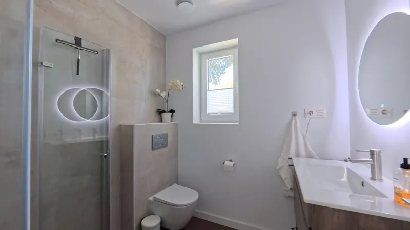 Upper Floor Bathroom: Glass Shower Enclosure & Vanity